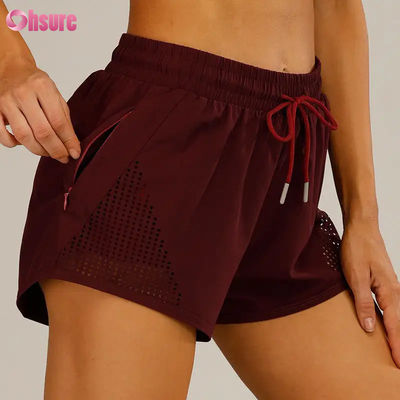 Giubbotti da allenamento sportivo per donne al dettaglio Breathable Laser Cut Jogging Shorts with Warm-up Zipper Side Pocket Solid Pattern
